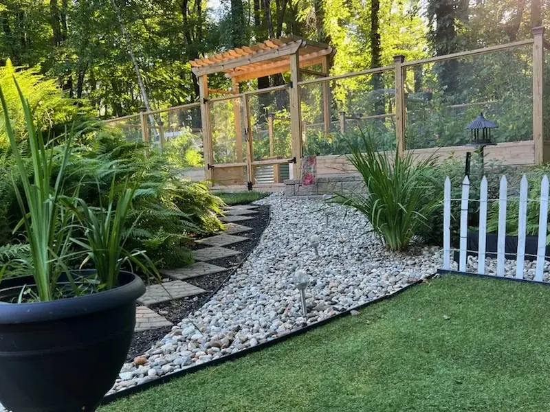 Garden gate and curving stone path showing integrated landscape design