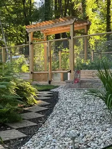 Garden gate reached by a curving stone path
