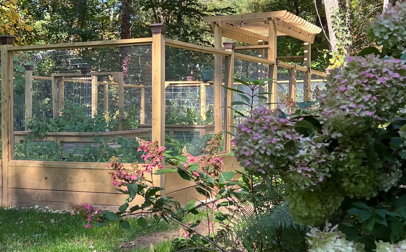 Enclosed garden tucked into a flowering landscape